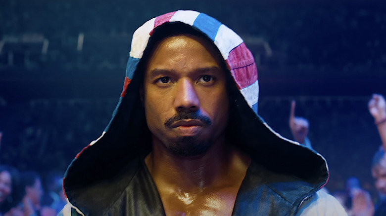 Adonis Creed wearing hood walking stadium