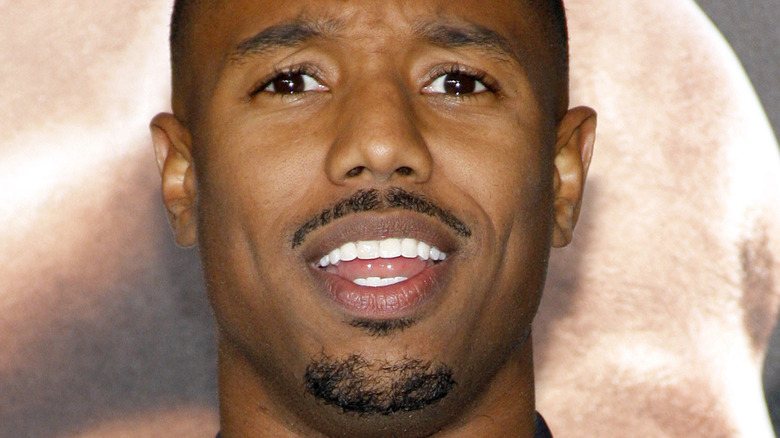 Michael B. Jordan at event smiling