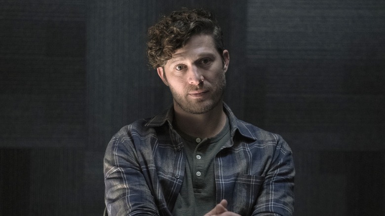Zach Gilford as Voit staring
