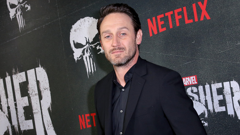 Josh Stewart posing on red carpet