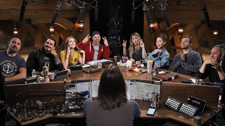 Critical Role cast sits around a table together