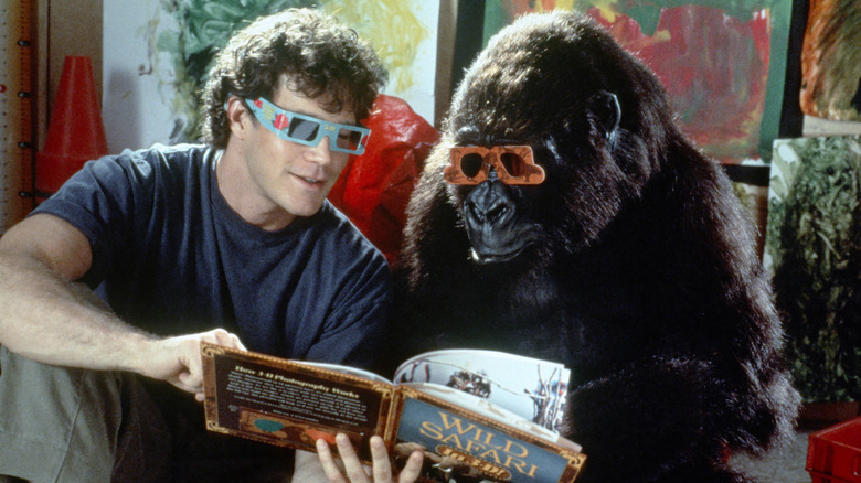 Amy and Peter Elliot look at a book in "Congo"