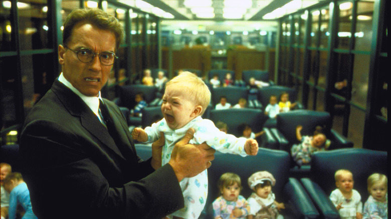 Dr. Alex Hesse holds out a baby in horror in "Junior"