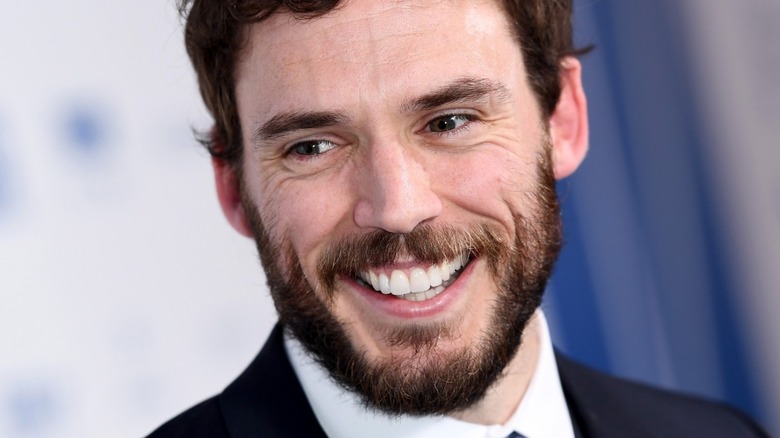 Sam Claflin smiling on red carpet