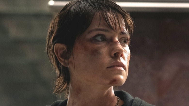 Joey covered in dirt, turns her head in Cleaner (2025)