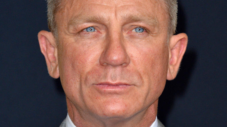 Daniel Craig smirking at a press event for Knives Out