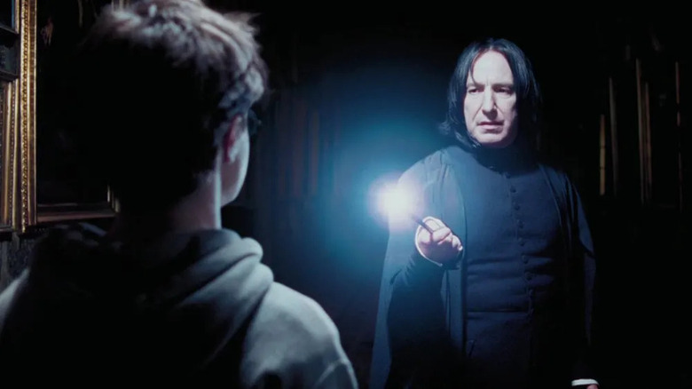 Snape pointing wand at Harry
