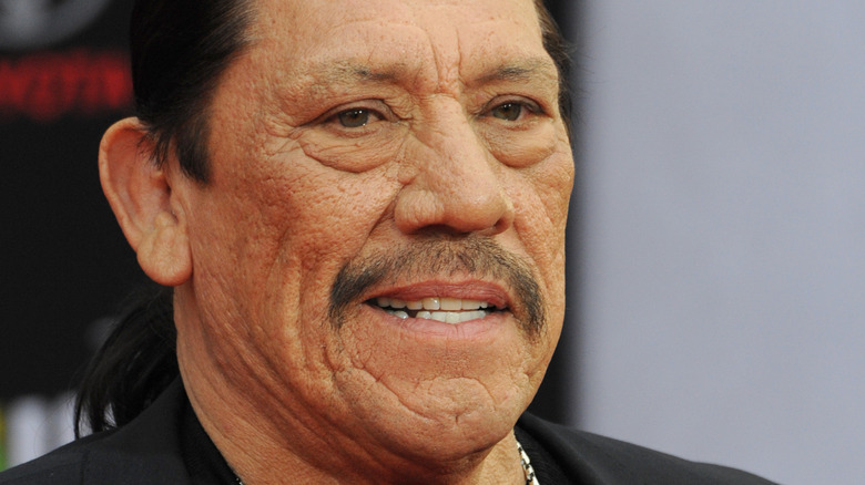 Danny Trejo with a side grin