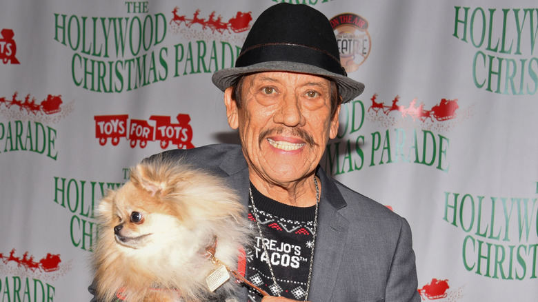 Danny Trejo holding Pomeranian