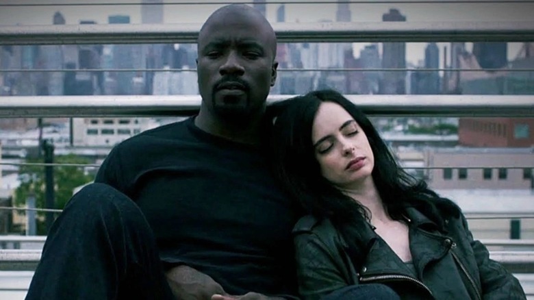 Jessica Jones leaning on Luke Cage