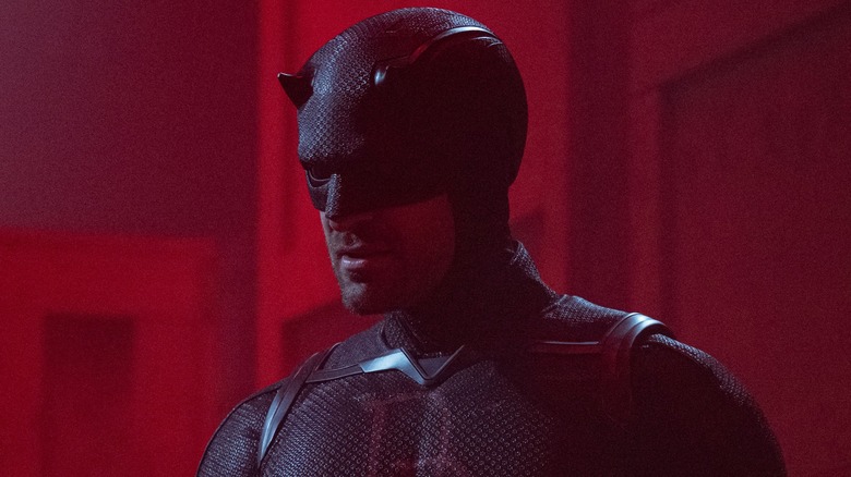 Daredevil wearing black suit under red light in 