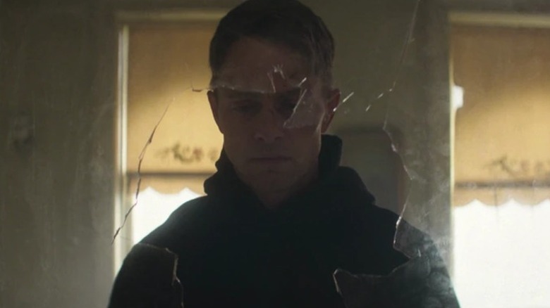 Bullseye looks out of a broken window on Daredevil: Born Again