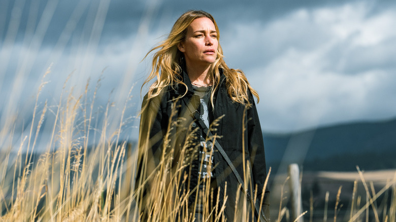 Summer Higgins standing in tall grass in "Yellowstone"