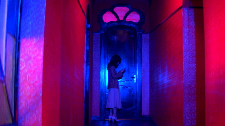 Suzy standing in a hallway