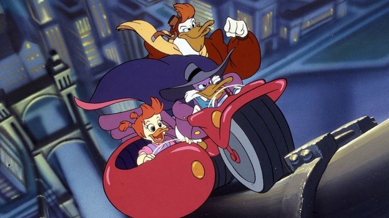 Darkwing Duck, Launchpad McQuack, and Gosalyn Mallard riding a motorcycle up a bridge cable