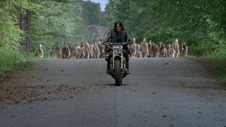 Daryl riding away from the undead on his custom bike