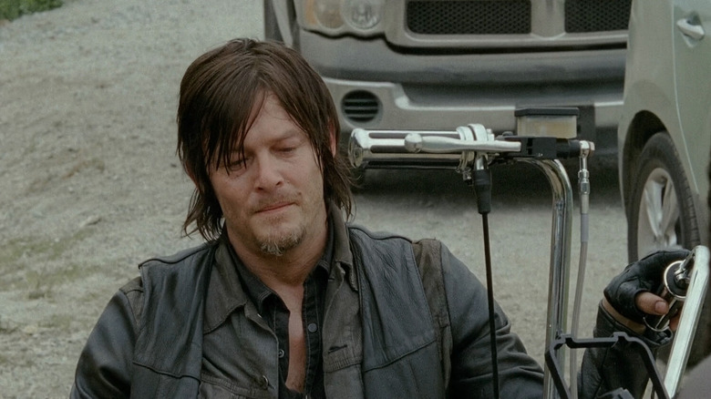 Daryl holding chopper handlebars