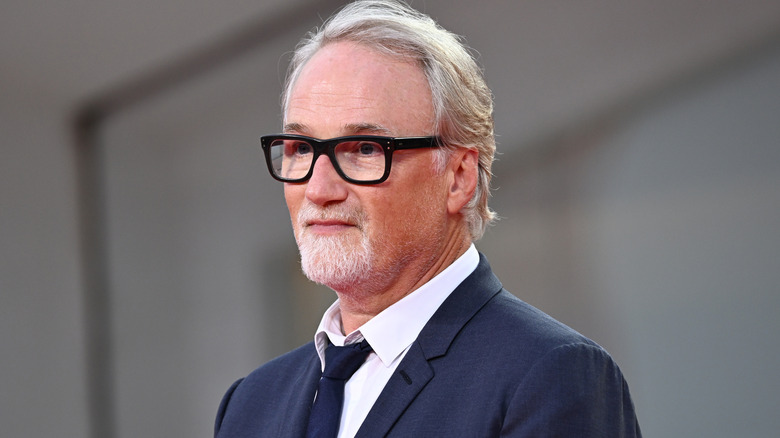 David Fincher posing at event for 