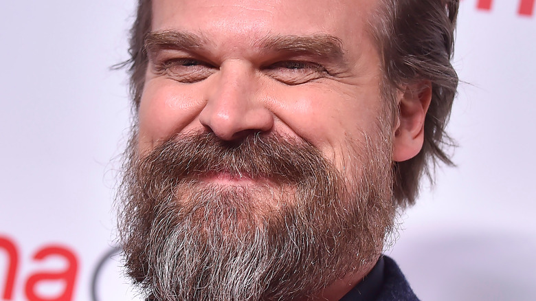 David Harbour with beard smiling