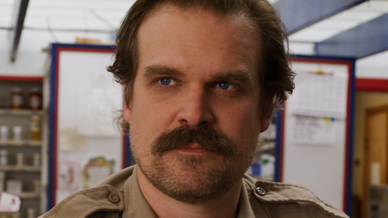 Jim Hopper smiling and wearing police uniform