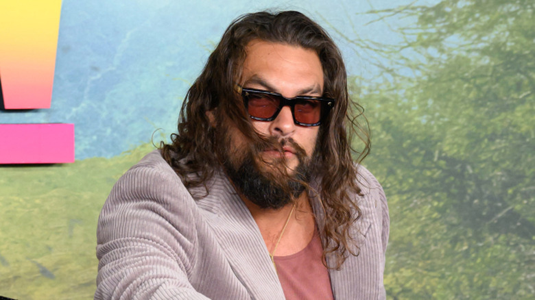 Jason Momoa on a motorcycle on a red carpet