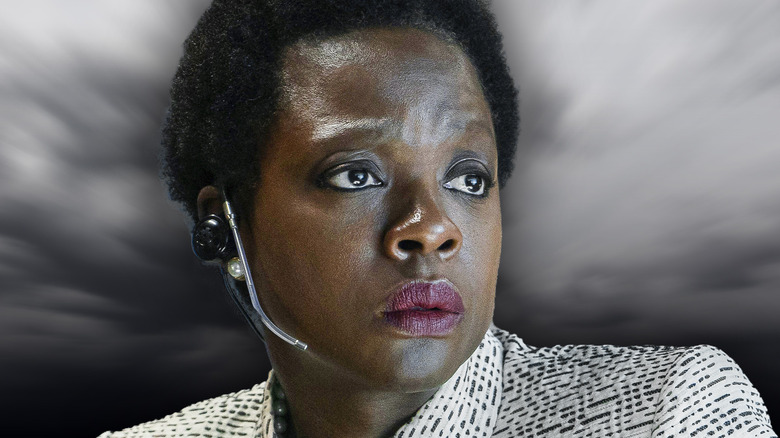 Amanda Waller looking serious with a grey background