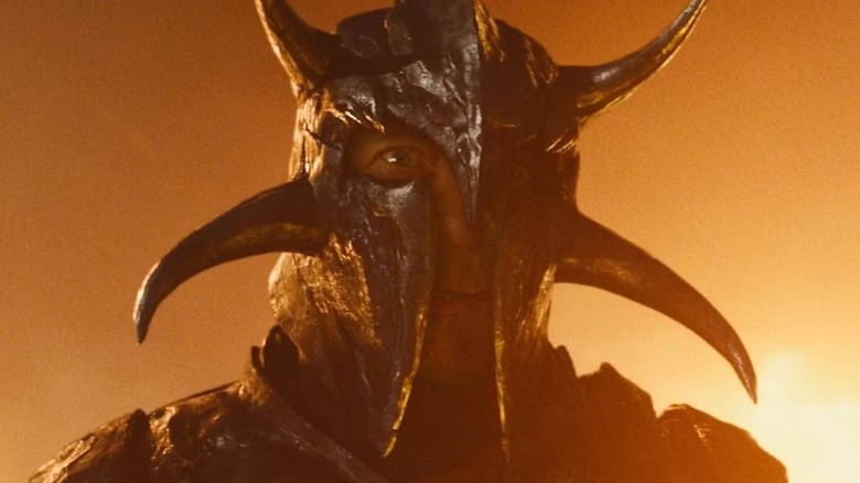 Ares with fire in the background in Wonder Woman