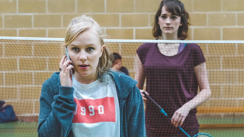 Meg on phone with Alison playing badminton