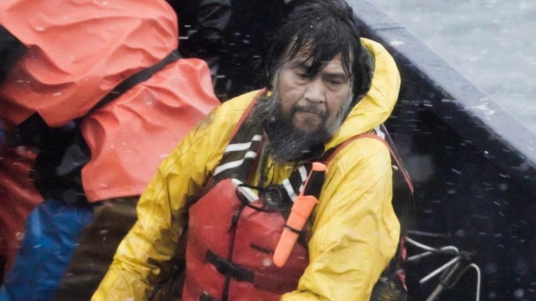 Fisherman in lifejacket on boat