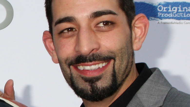 Josh Harris smiling for press photo