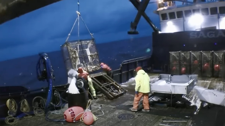 Fishing crew secures crab pot 