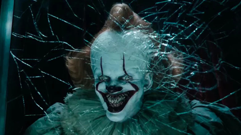 Pennywise the Dancing Clown with a terrifying grin in It: Chapter Two