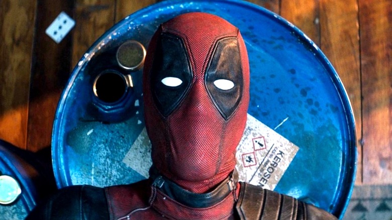 Deadpool lays atop barrels