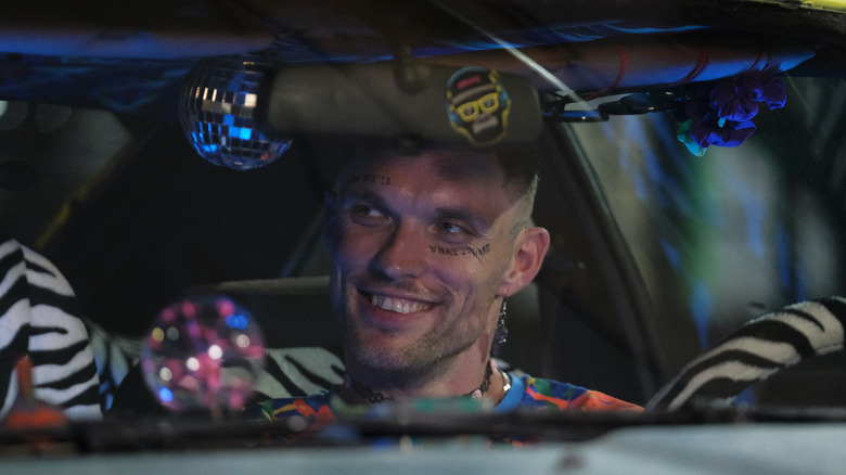 Fuzz smiling in his car