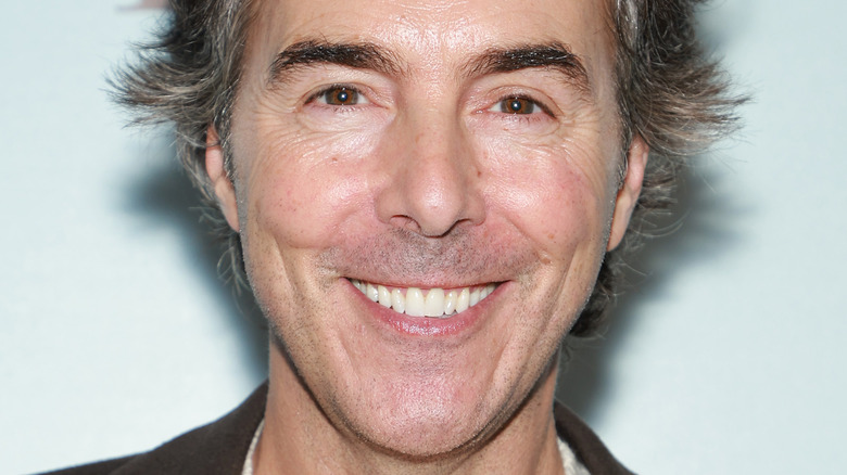 Shawn Levy smiling with his hair fanned out behind him