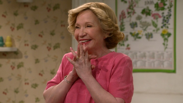 Kitty Forman wearing a pink shirt