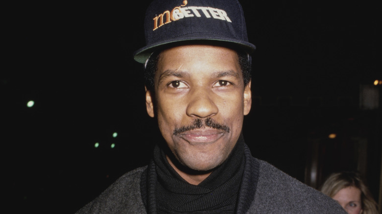 Denzel Washington smiling with a 'Mo' Better Blues' baseball cap on (1990)
