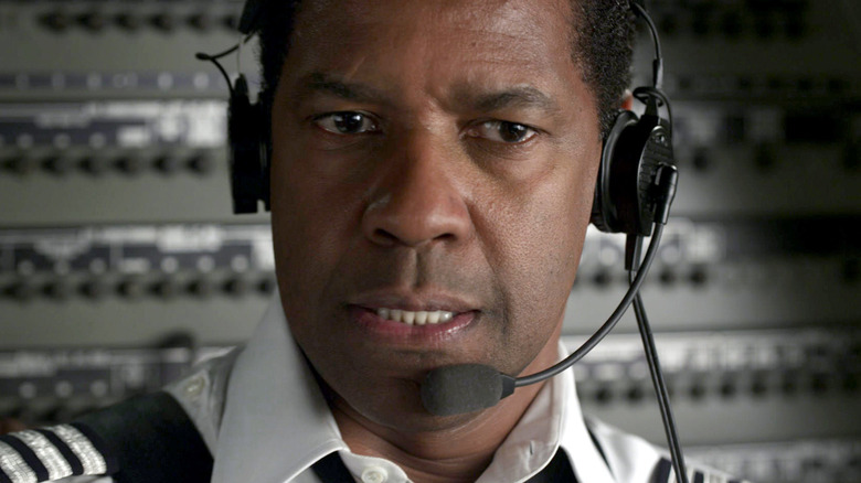 Captain Whitaker in the cockpit on headset in 