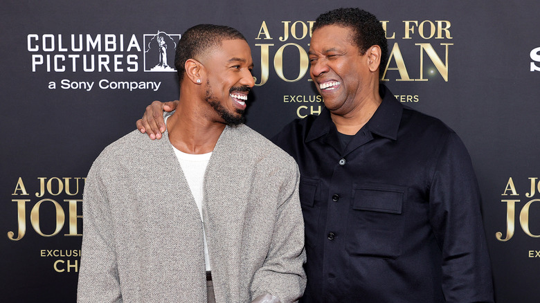 Michael B. Jordan and Denzel Washington laughing together at the premiere of A Journal For Jordan