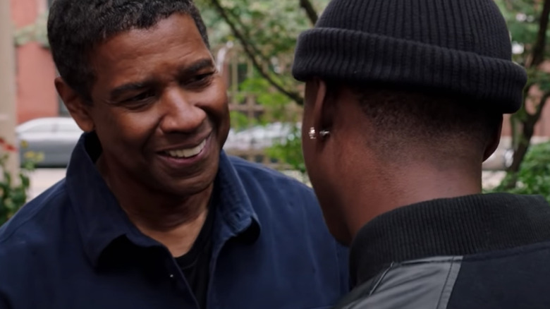 Denzel Washington smiling at Ashton Sanders