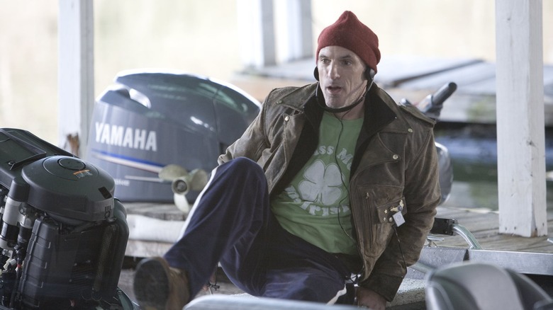 Waylon Forge standing on his boat with headphones in