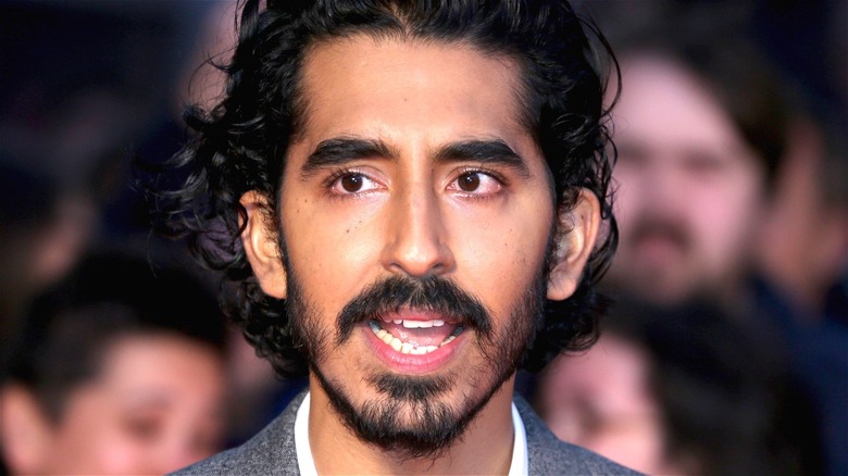 Dev Patel posing and talking