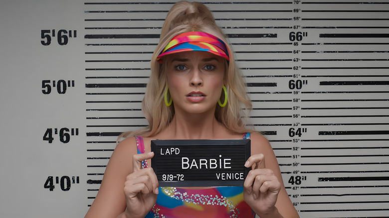Barbie having a police mug shot taken
