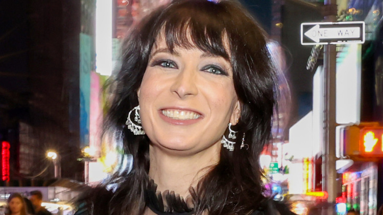 Diablo Cody holding an award and smiling