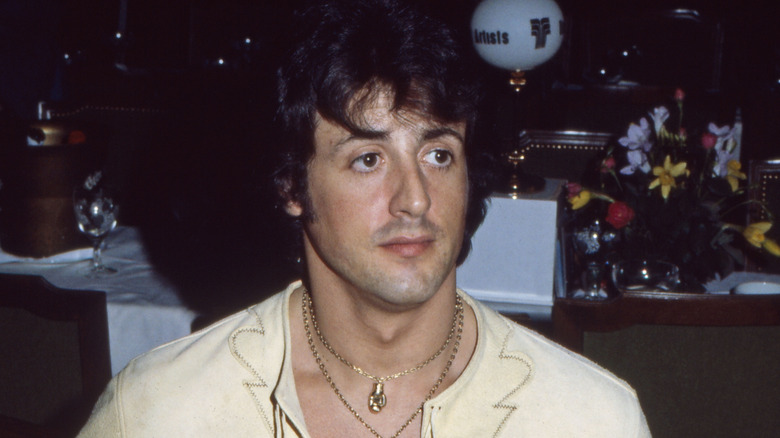 Sylvester Stallone sitting in a restaurant