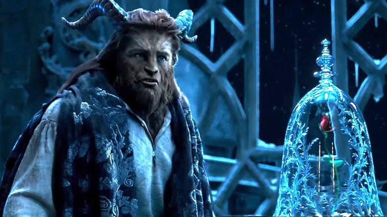 The Beast stands next to the rose in Beauty and the Beast