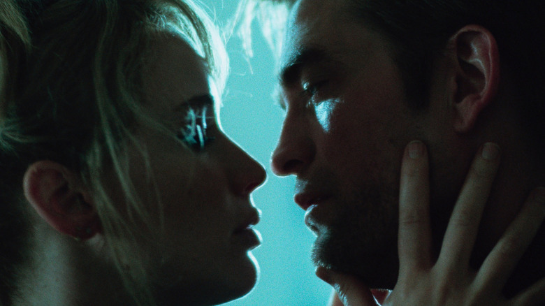 Grace touches Jackson's face leaning in to kiss in "Die My Love" (2025)