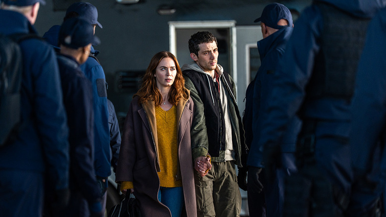 Margaret and Daniel moving through a crowd of Wardex operatives in "Disclosure Day" (2026)