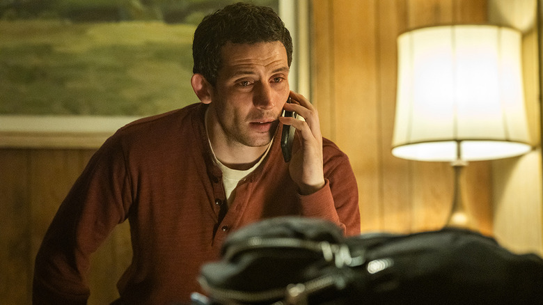 Daniel talking on the phone in a hotel room in "Disclosure Day" (2026)
