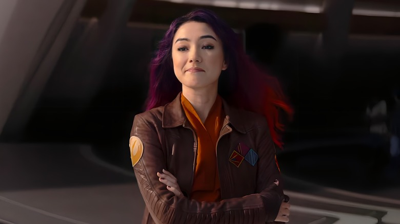 Sabine standing with arms crossed